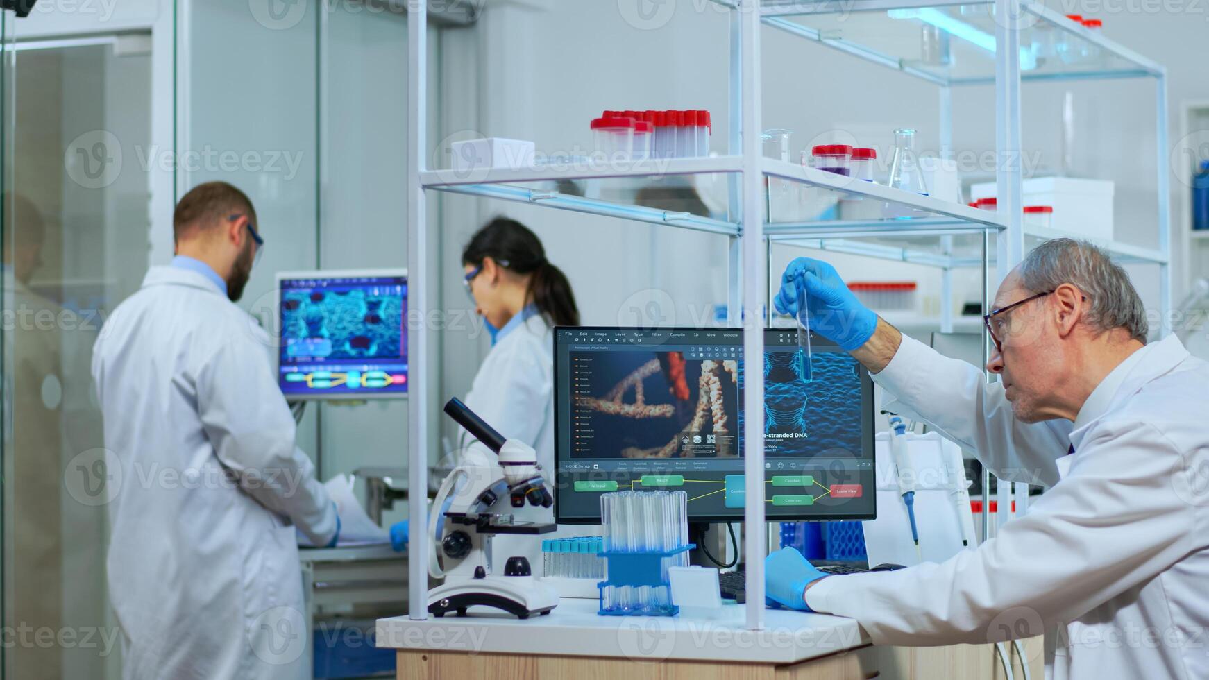 Elderly man technologist doing a laboratory test examining a flask with a blue substance, chemist holding tube with liquids inside. Scientist working with various bacteria tissue and blood samples photo