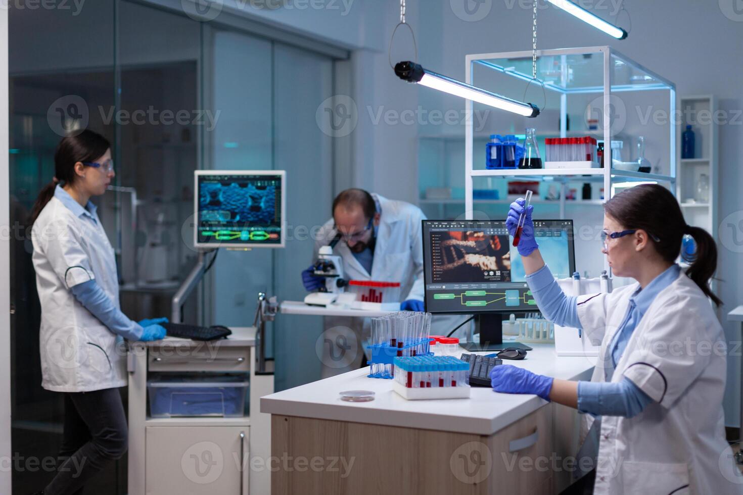 Professional doctor scientist looking in computer analysing DNA image scan. Chemists in pharmaceutical laboratory examining sample for medical experiment with technology for medicine industry. photo