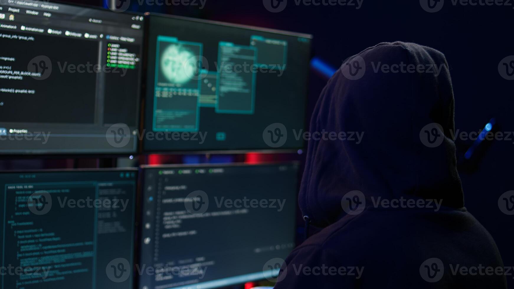 Dangerous man hacking, stealing credit card numbers and infiltrating banking systems, handheld camera shot. Close up of hacker running code in apartment on PC monitors, camera B photo