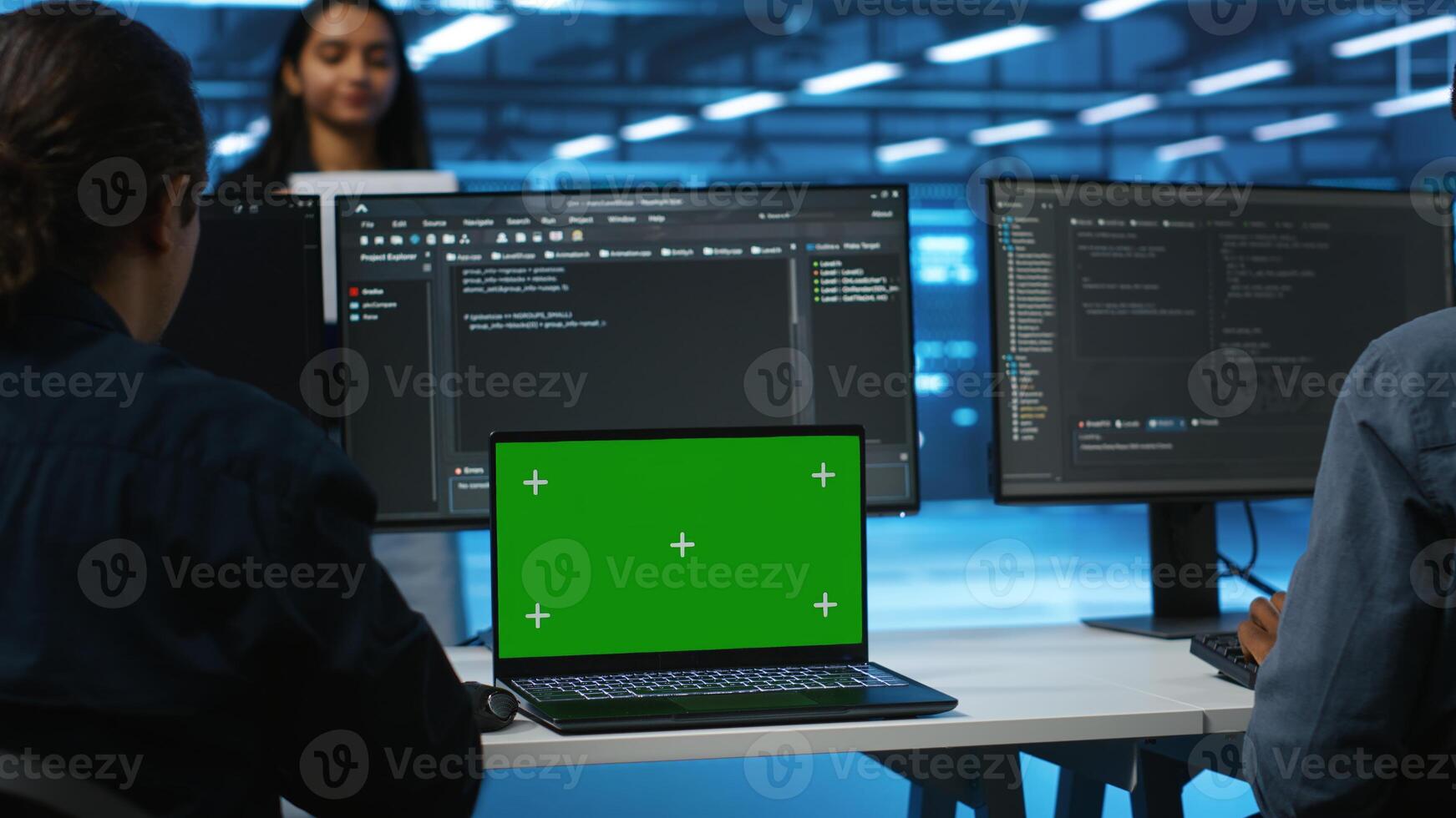 Manager in server hub supervising engineers looking for misconfiguration using isolated screen device. Woman coordinating experts mending data center bugs with mockup notebook, close up panning shot photo