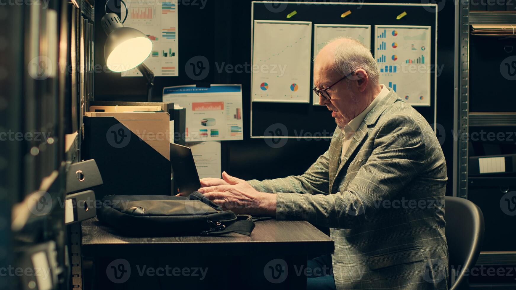 Senior private agent studying federal statements and case details to connect the dots, researches legal precedents. Law officer reinvestigating archived cases based on new evidence. Camera A. photo