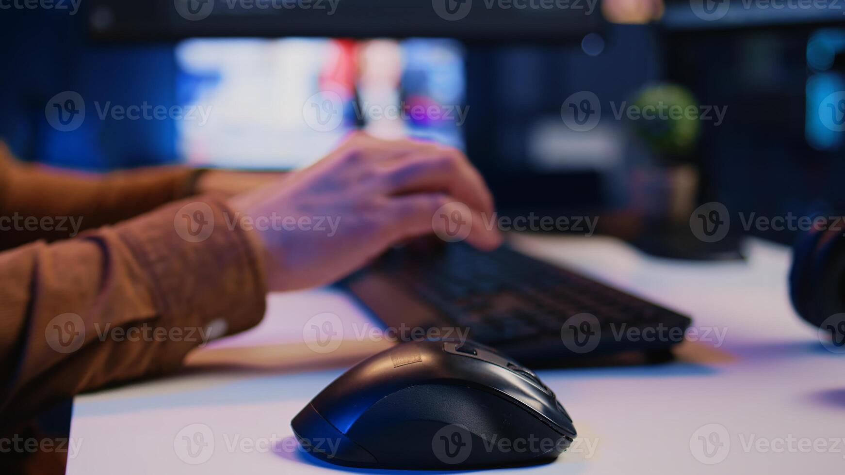 Focus on computer peripherals used by programmer to write lines of code on PC screen. Close up shot of keyboard and mouse used by developer working on fixing database errors, camera B photo