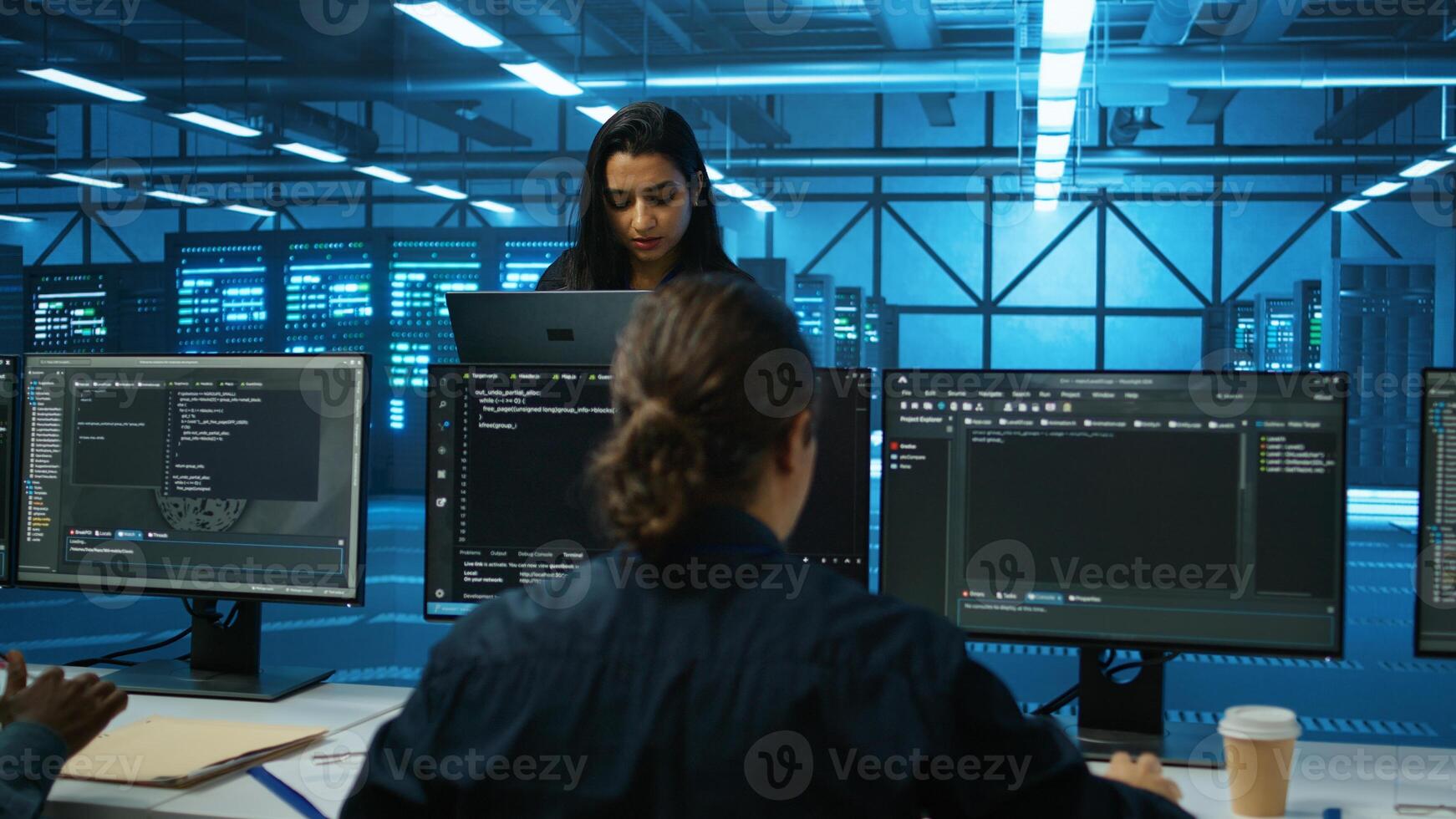 Smiling admin in server hub checking recovery plan, monitoring data center energy consumption across components, making sure sensors are functioning optimally, doing routine disk checks photo