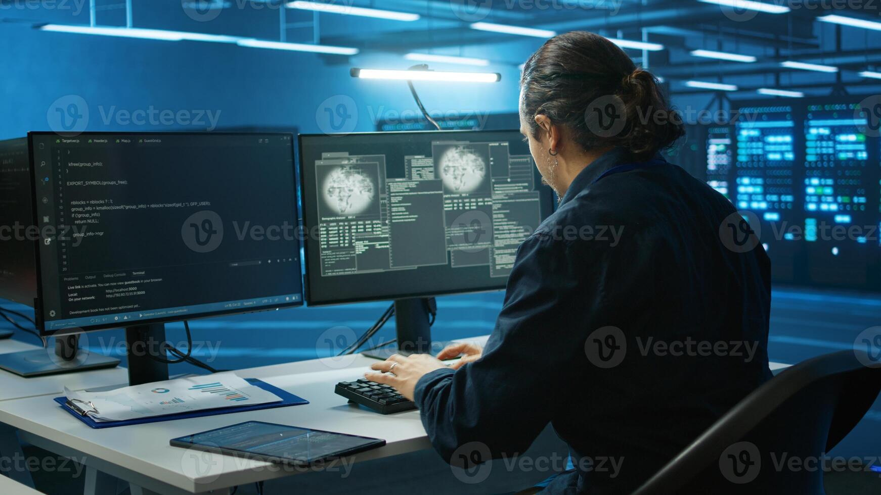 System administrator in server room frightened by sensitive data threatened by hacking attack on computers. Afraid man jumping out of desk chair, rushing to save data center from unauthorized access photo