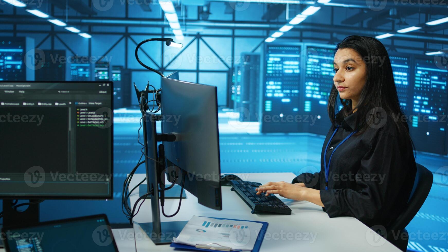 IT engineer in data center using PC to find misconfigurations affecting rackmounts performance. Woman checking servers bottlenecks leading to sluggish data transfer rates and malfunctions photo