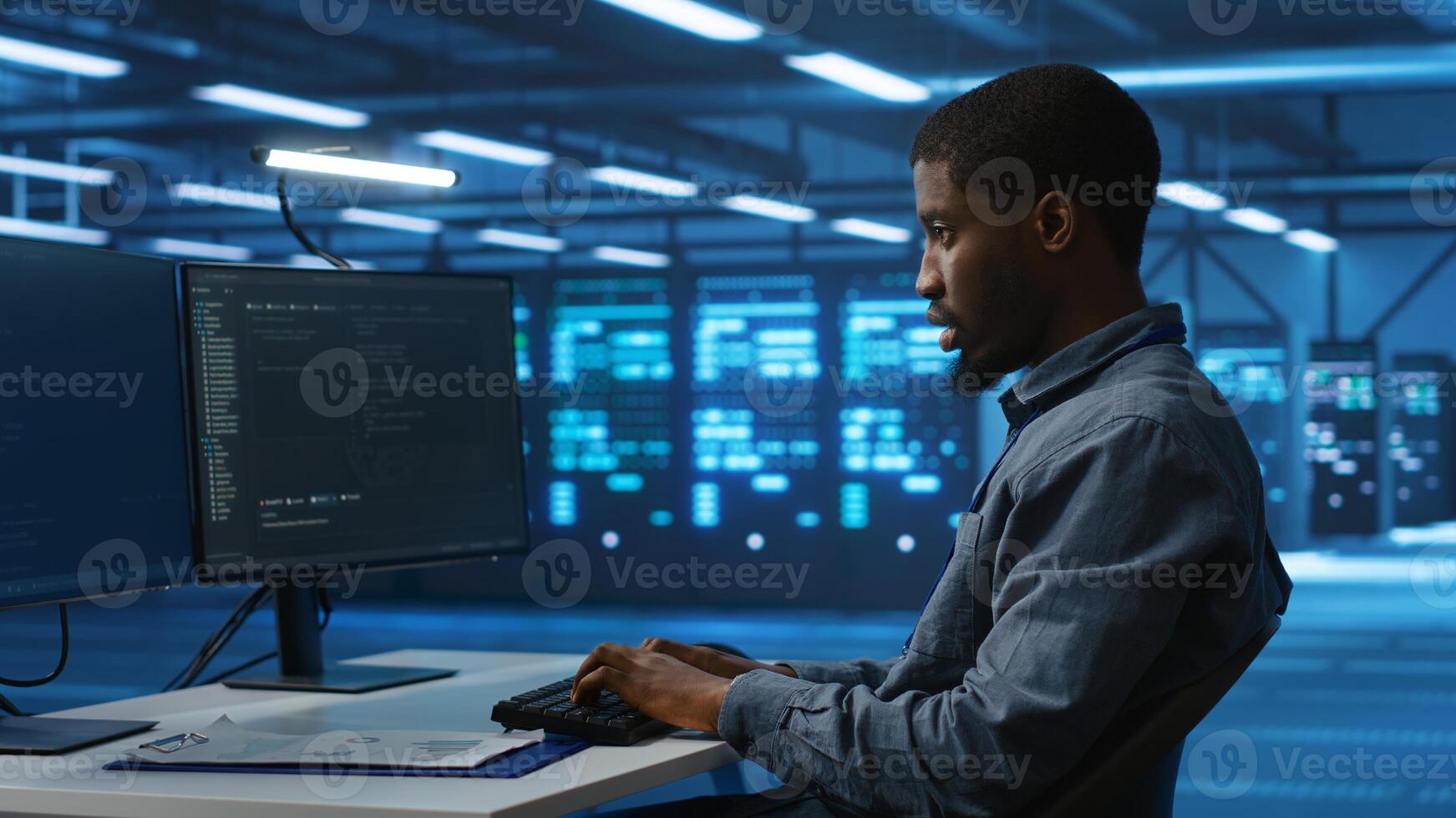 Software developer programming in high tech facility with server rows providing computing resources for different workloads. IT expert supervising data center supercomputers photo