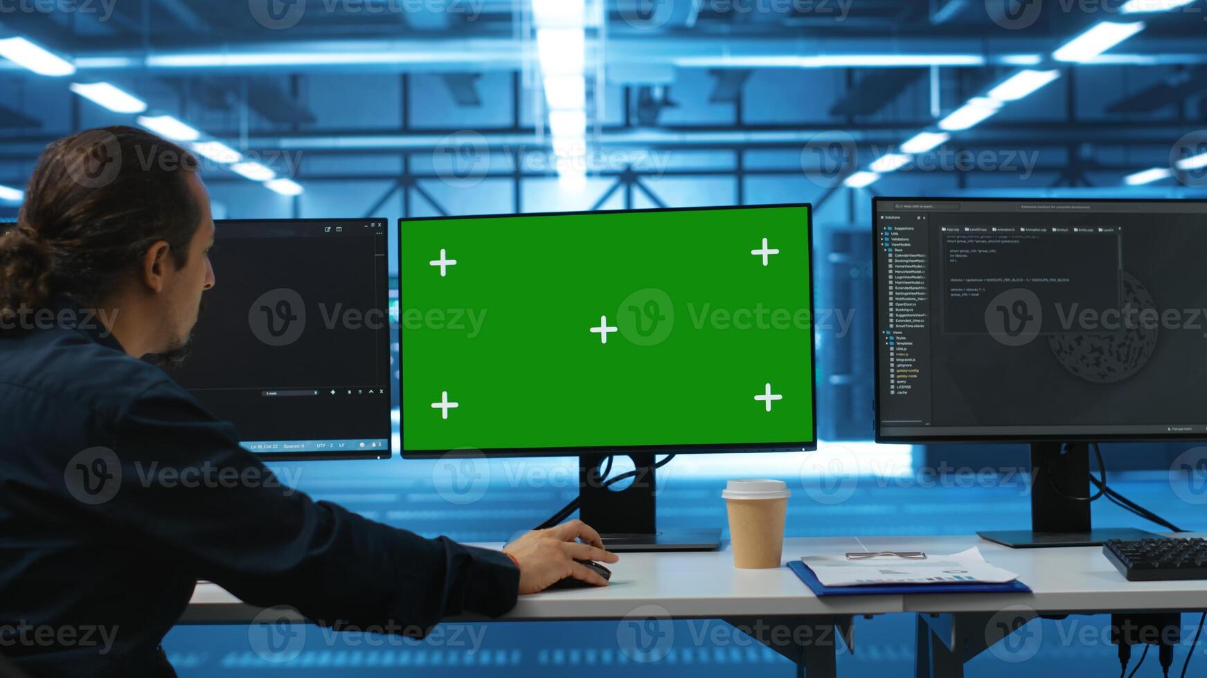 Software developer using green screen PC to do programming in server room providing computing resources for workloads. IT expert supervising data center supercomputers using mockup computer monitor photo