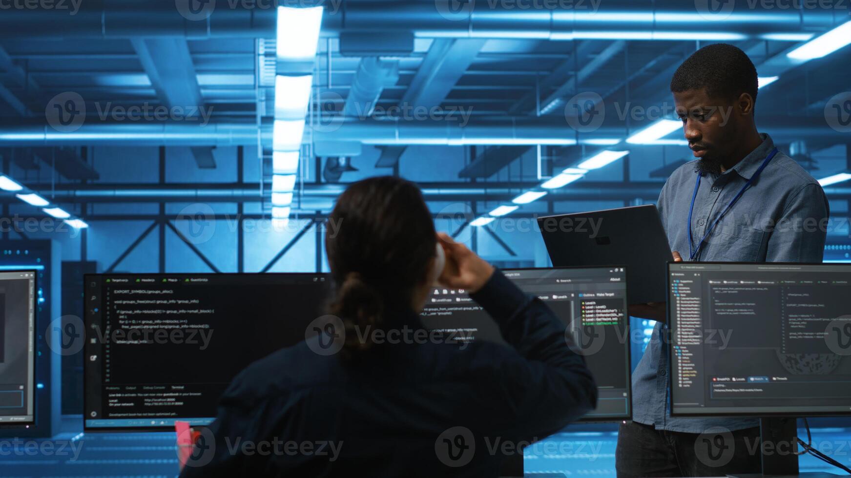 Manager overseeing IT technicians in server hub repairing equipment storing datasets. Team leader at work in data center supervising workers mending rigs doing computational operations photo