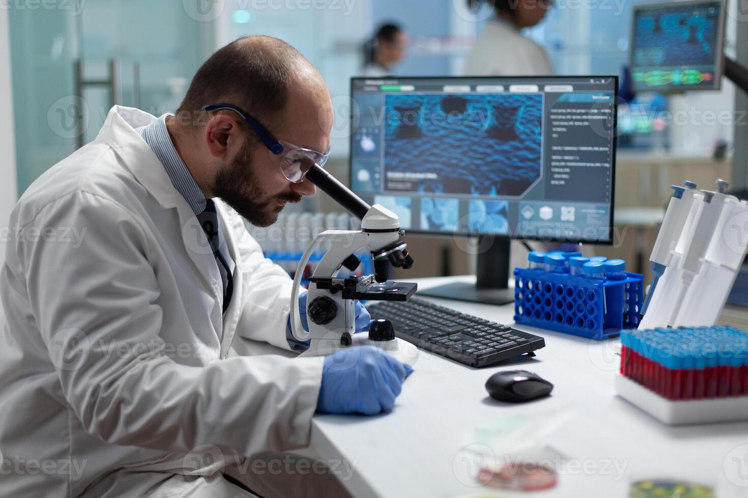 Specialist virus researcher analyzing coronavirus result using clinical microscope developing medical vaccine during biomedical investigation in scientific hospital laboratory. Disease examination photo