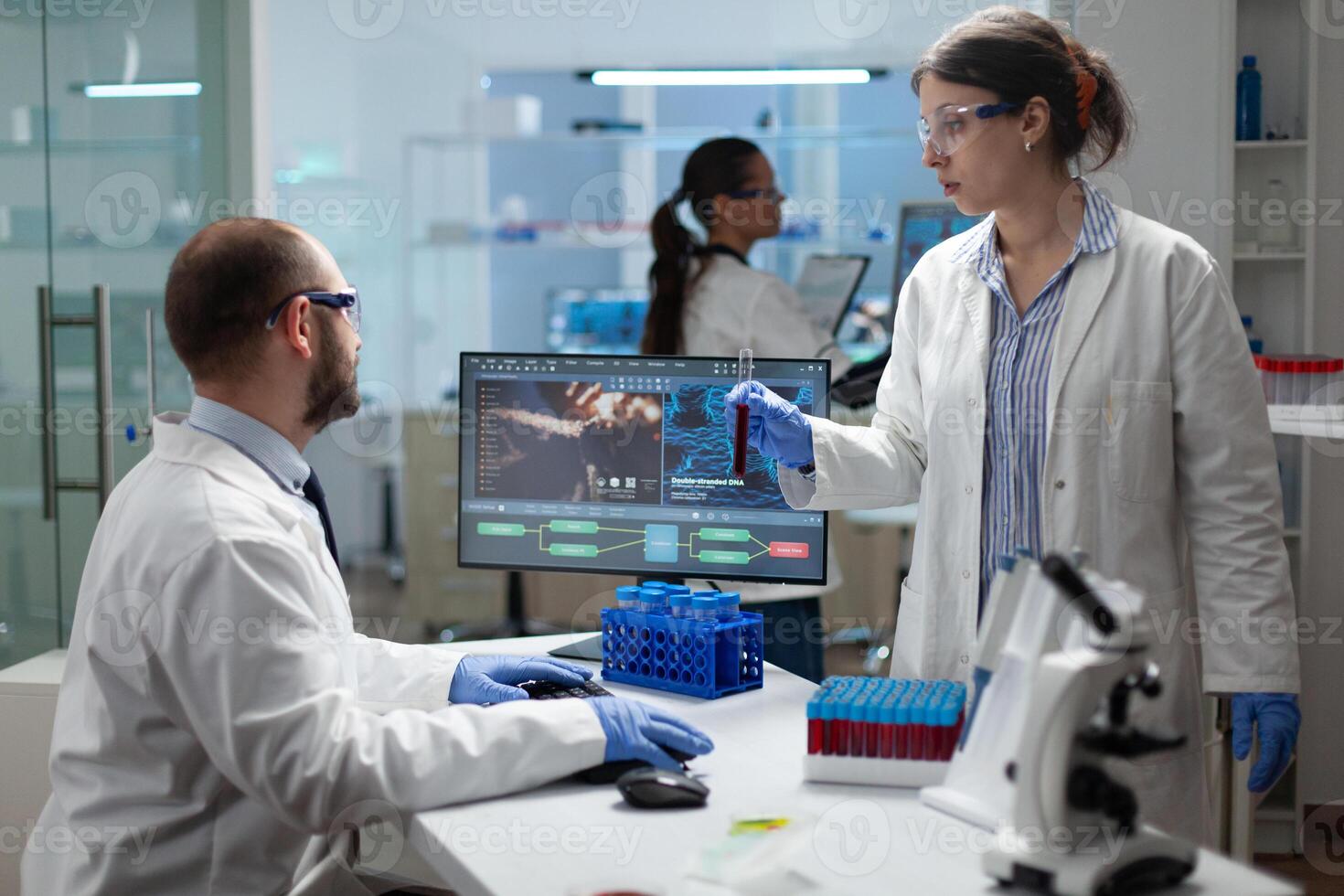 Medical team examining blood sample discussing virus expertise during medicine experiment in biochemistry laboratory, Chemist researchers discussing healthcare treatment, Biomedical investigation photo