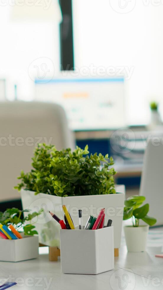 Modern business meeting zone interior with conference table and white chair. Brainstorm area in business center with nobody in it, shot of empty room with modern furniture, white shelves and blue wall photo