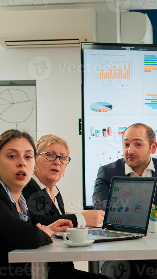 Pov of diverse team sitting in conference room during virtual meeting, discussing online with business partners. Internet conference call technology talk with investors, corporate brainstorming via web photo