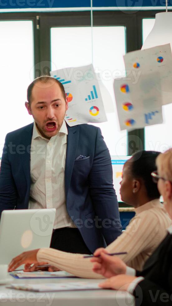 Nervous businessman quarrelling in coworking having conflict at workplace blaming accuses for bad work incompetence mistakes. Reprimanding unsuccessful results and rivalry concept. photo
