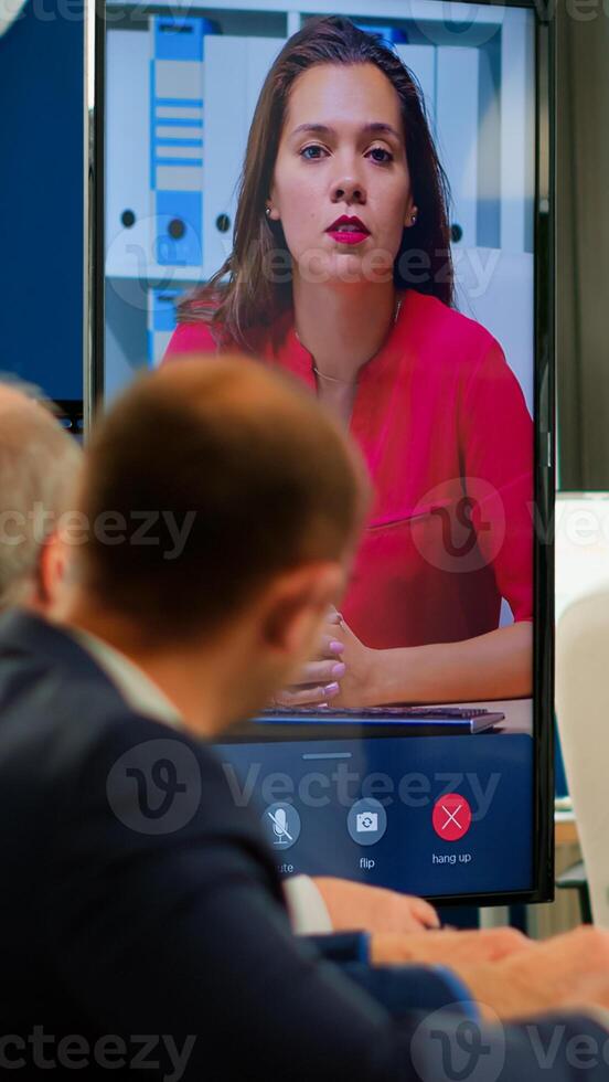 Young ceo speaking to camera during virtual business presentation for business partners. Confident businesswoman talking to web cam streaming webcast training, doing online conference call. photo