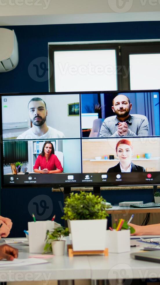 Team working by group call share ideas brainstorming negotiating use conference, pc screen view multi ethnic young people. Diverse people talking at virtual meeting, online discussion. photo