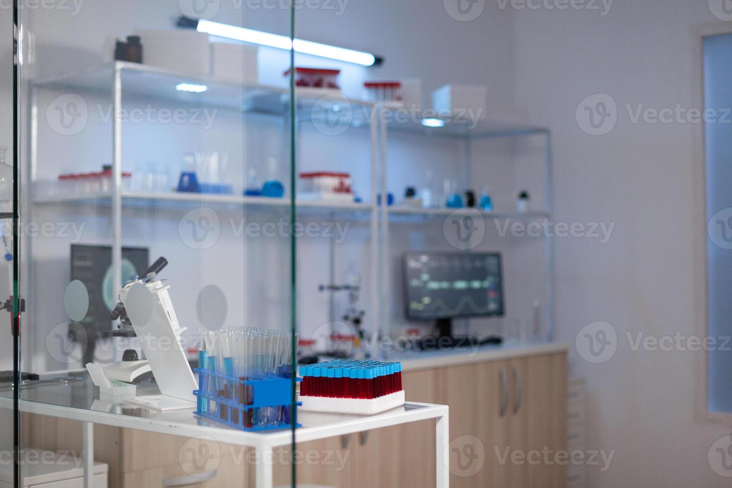 Empty medical neuroscience laboratory with nobody in it with professional equipment ready for neurological experiment. Lab with brain scan on monitor. Medicine industry with high tech facility photo