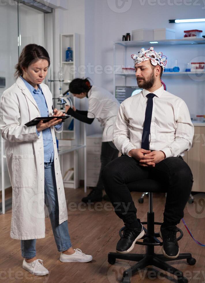 Neurologist woman monitoring brain evolution developing medical treatment for neurological disease in modern laboratory. Scientist doctor analyzing nervous system activity. Neurology service photo