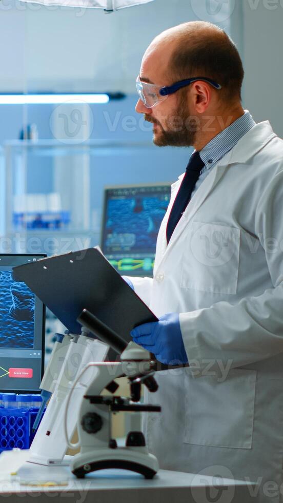 Chemists coworkers planning conducting vaccine against new virus in modern equipped laboratory. Chemists stuff analysing evolution using high tech for researching treatment against covid19 photo