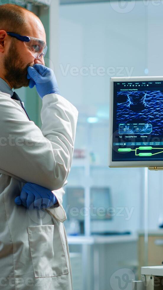 Team of chemists working with DNA scan image looking at desktop standing in medical research laboratory, analysing biochemicals samples, talking. Microbiology development with advanced equipment photo