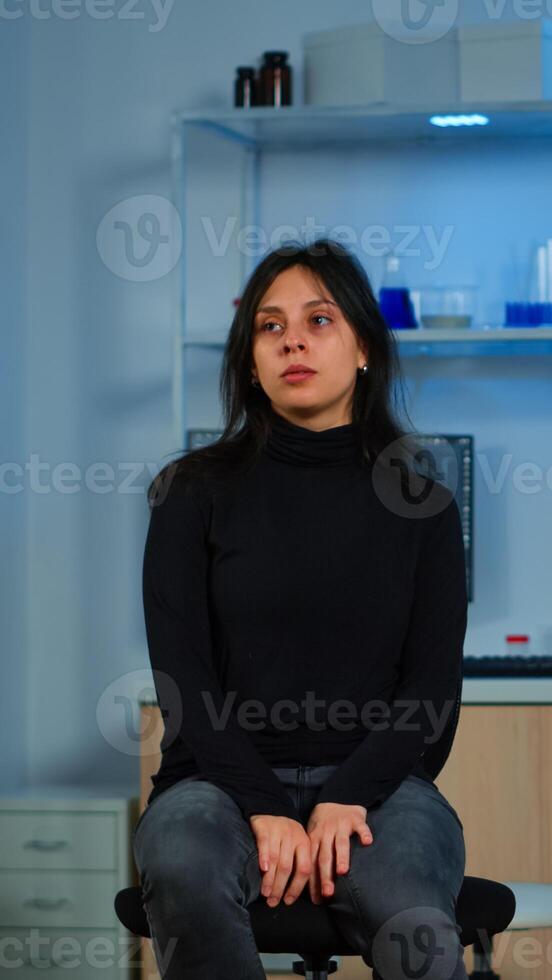 Wired patient waiting scientist doctor in neurological research laboratory visiting scientists examining tomography scan. Woman sitting in lab equipped for development of experiments photo