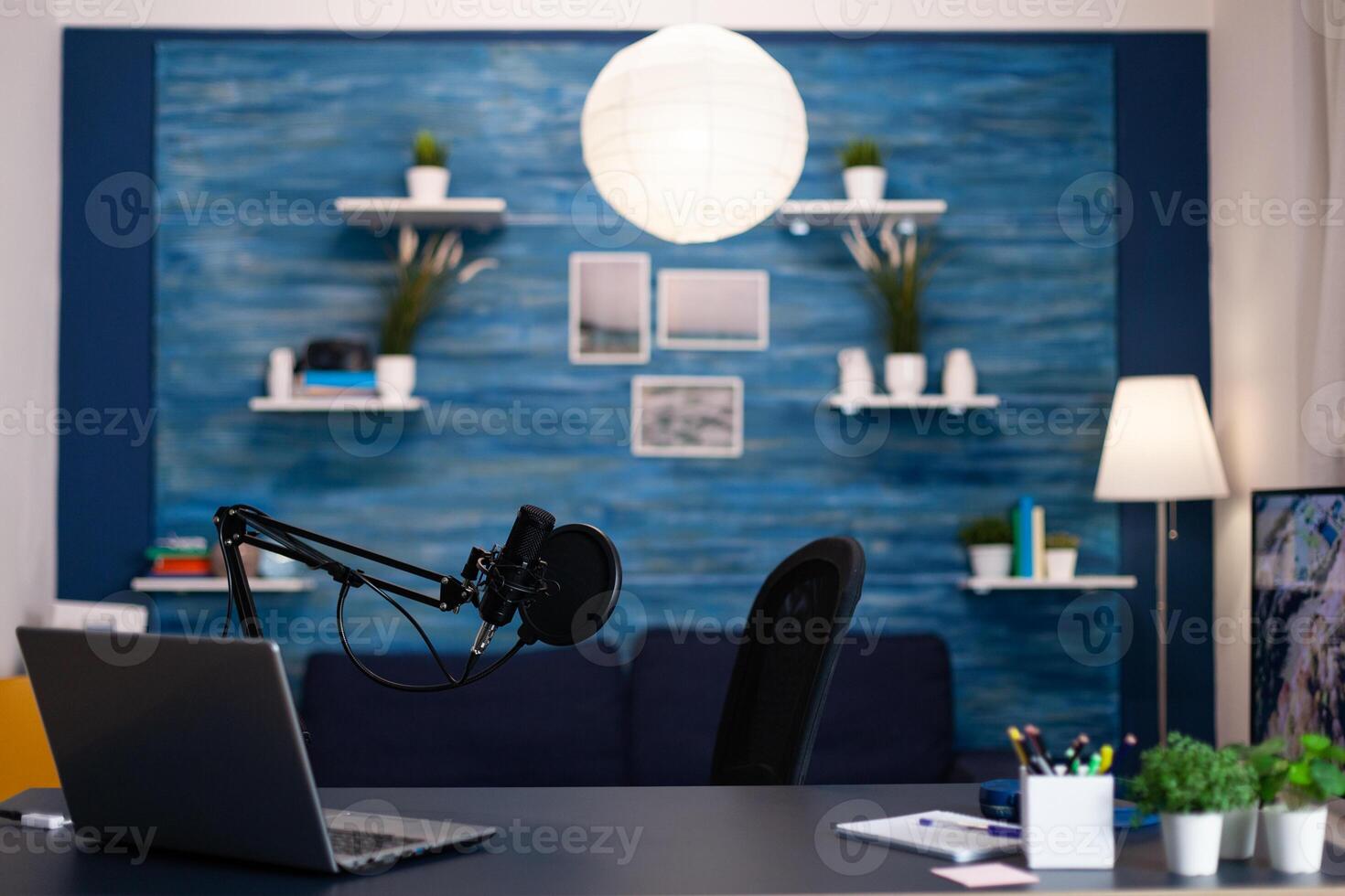 Empty podcast studio with nobody in it equipped with professional production podcasting equipment ready for entertainment vlog. Digital web internet streaming station. On-air show in living room photo