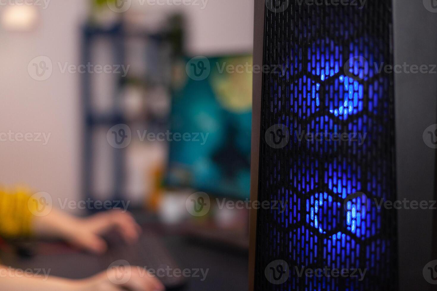 Closeup of RGB led lights powerful computer, woman gamer playing space shoother videogames during online competition. Gaming studio equipped with professional streaming setup photo