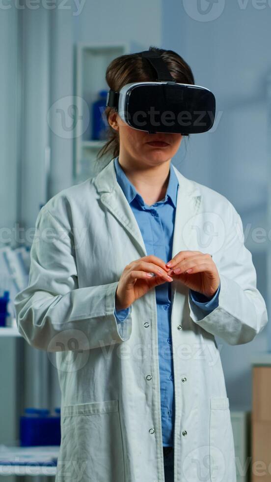Advanced neurological scientist using medical inovation in lab wearing virtual reality glasses, gesticulating. Team of researchers working with equipment device, future, medicine, healthcare, vision, simulator photo