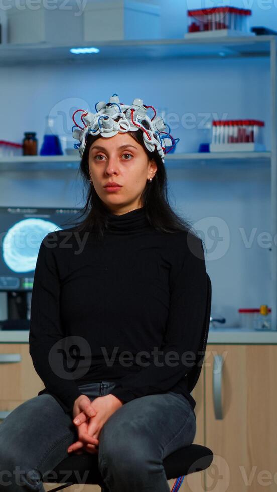 Researcher and patient with eeg headset looking at virtual display with touchscreen, virtual reality using medical inovation in neurological research lab. Scientists working with healthcare simulator photo