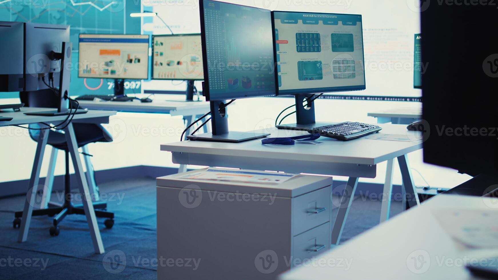 Empty telecommunications control room with workstations, coworking space equipped with a big screen and modern devices used in organizational daily tasks and projects. Camera B. photo