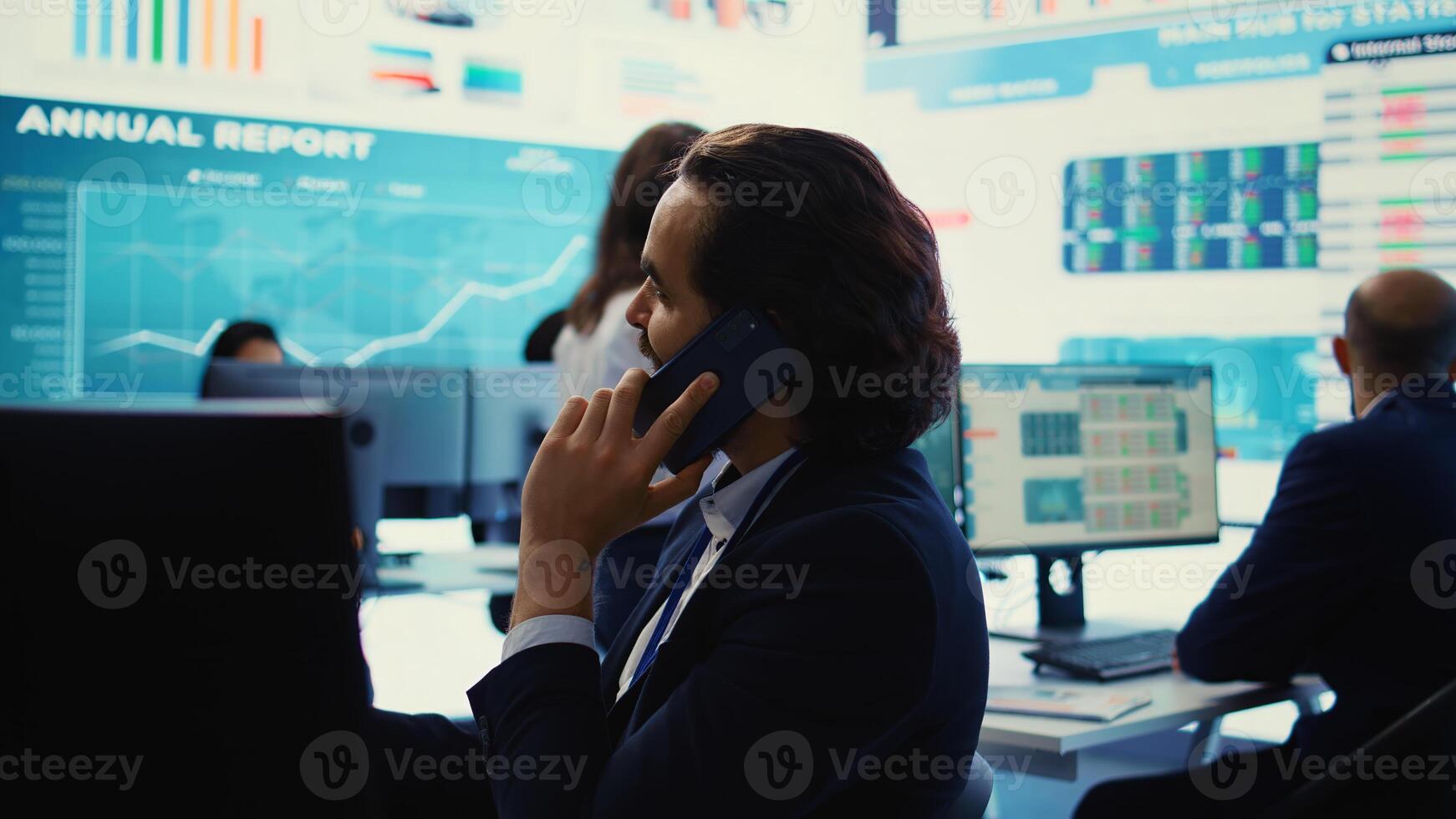 Chief financial officer sharing firm progress on a phone call with the main investor, ensuring performance based on current situation. Administrator works to expand enterprise budget. Camera B. photo