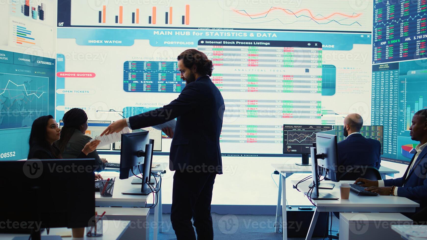 Financial manager briefing his team members about new corporation objectives, presenting their budget scheme with expenses. Resource allocation and project planning in control room. Camera B. photo