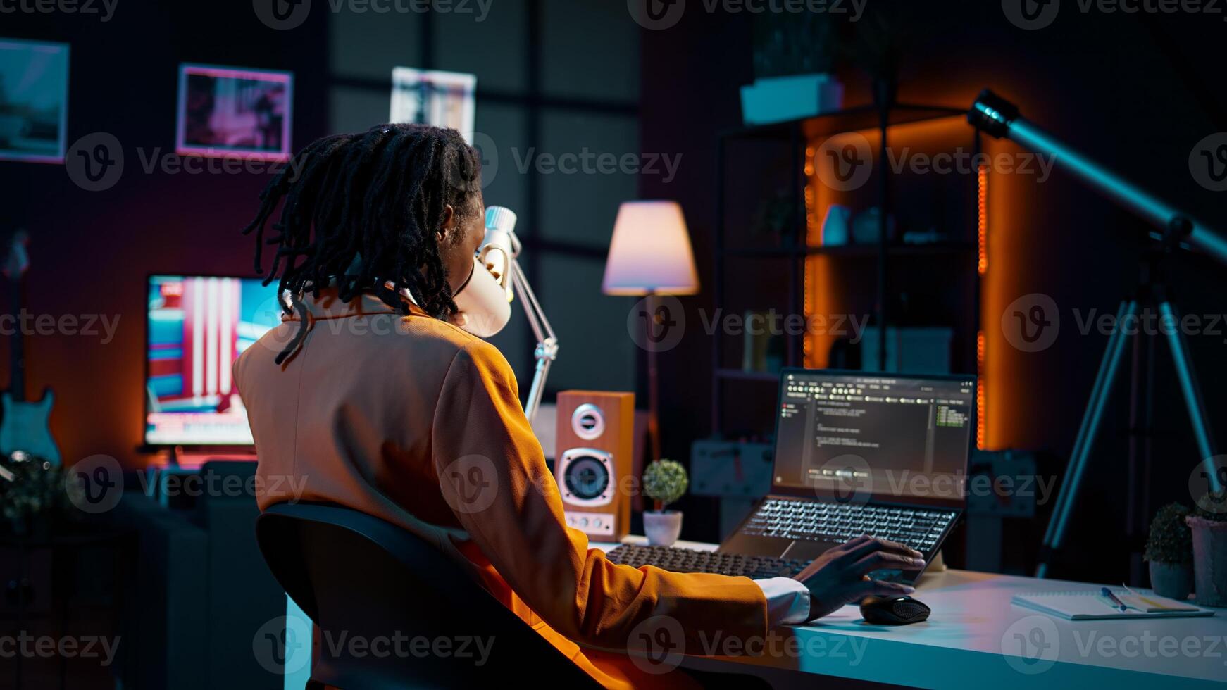 University student and coding enthusiast delves into cloud computing, expanding her knowledge beyond online class lessons. African american girl using programming language. Camera B. photo