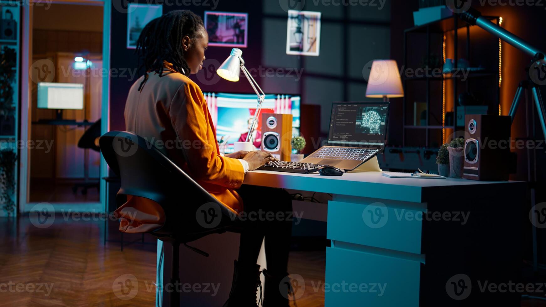 African american girl studying servers providing AI computing resources, learning to program html scripts on artificial intelligence neural network system. Woman uses coding language. Camera B. photo