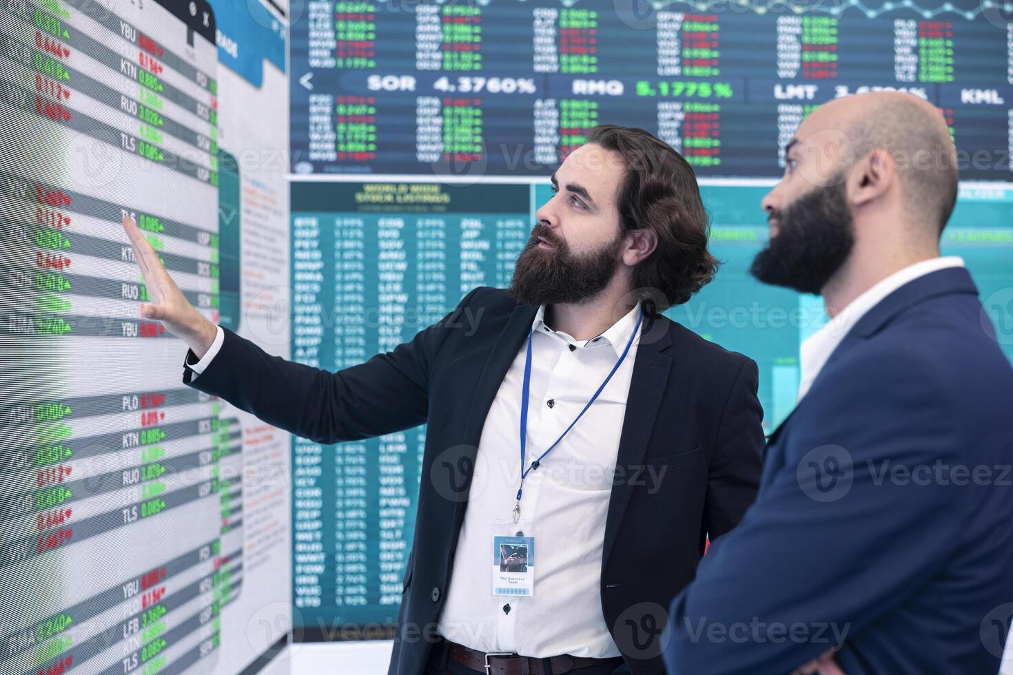 General director discussing with an investor to increase funding for a project, presenting performance metrics and annual data on a big screen. Business associates share strategies. photo