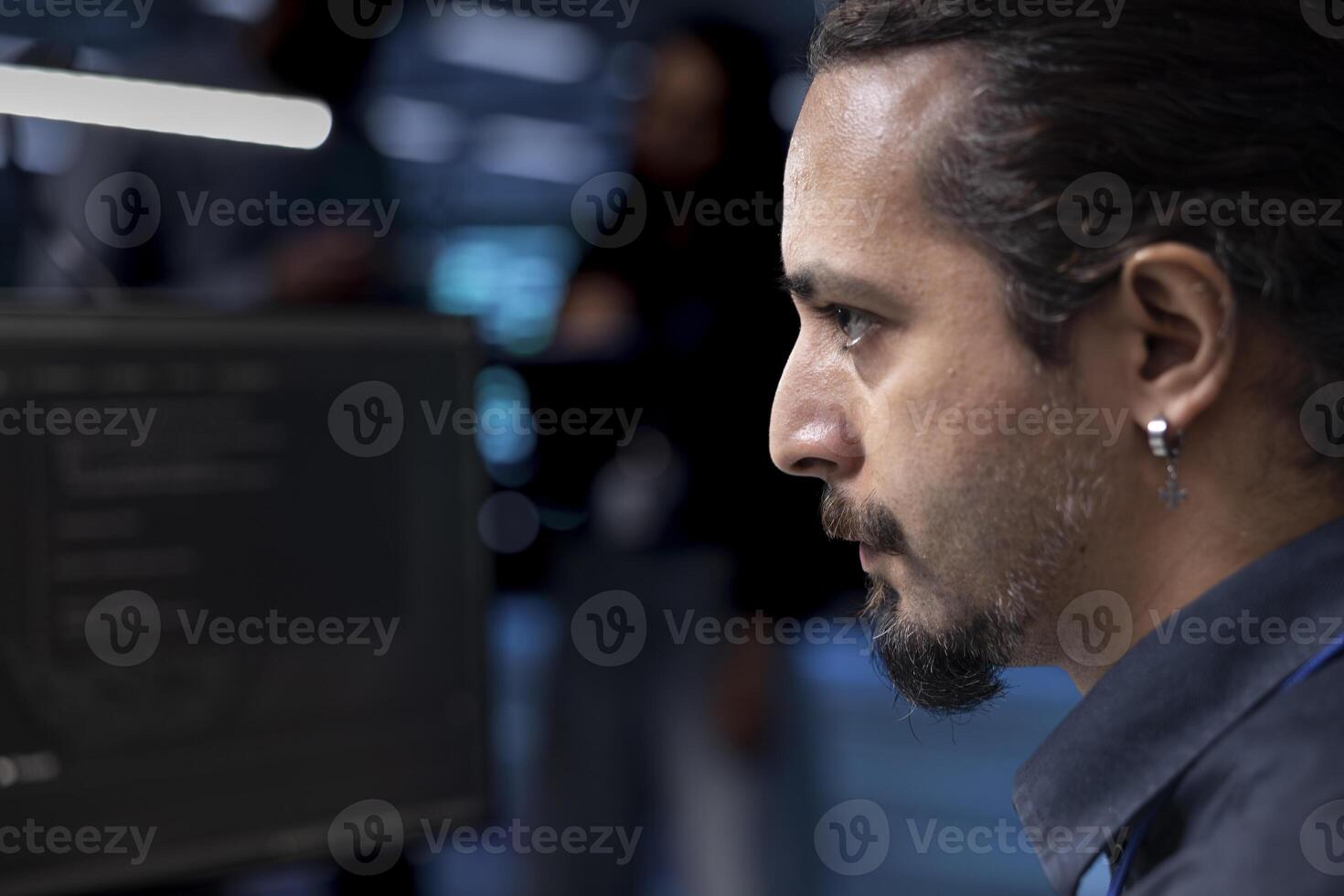 Programmer in server hub facility checking recovery plan, monitoring data center energy consumption. Worker in server room making sure sensors are functioning, doing disk checks, close up shot photo