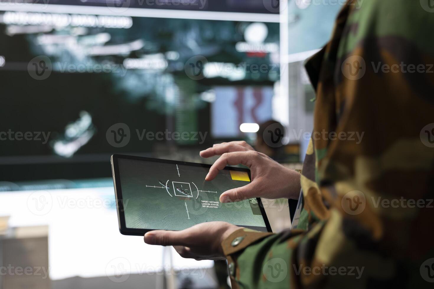 Military IT engineer collecting intelligence from world map projection, tablet connected to radar CCTV system to support soldiers in the field. Dispatch federal defense agency control room. Close up. photo