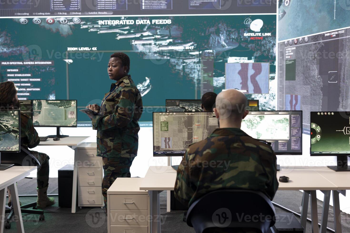 Female master sergeant gathers battlefield intelligence reports on a big screen, creating new plans for secret war operations. Reconnaissance division ensuring national safety in army power base. photo