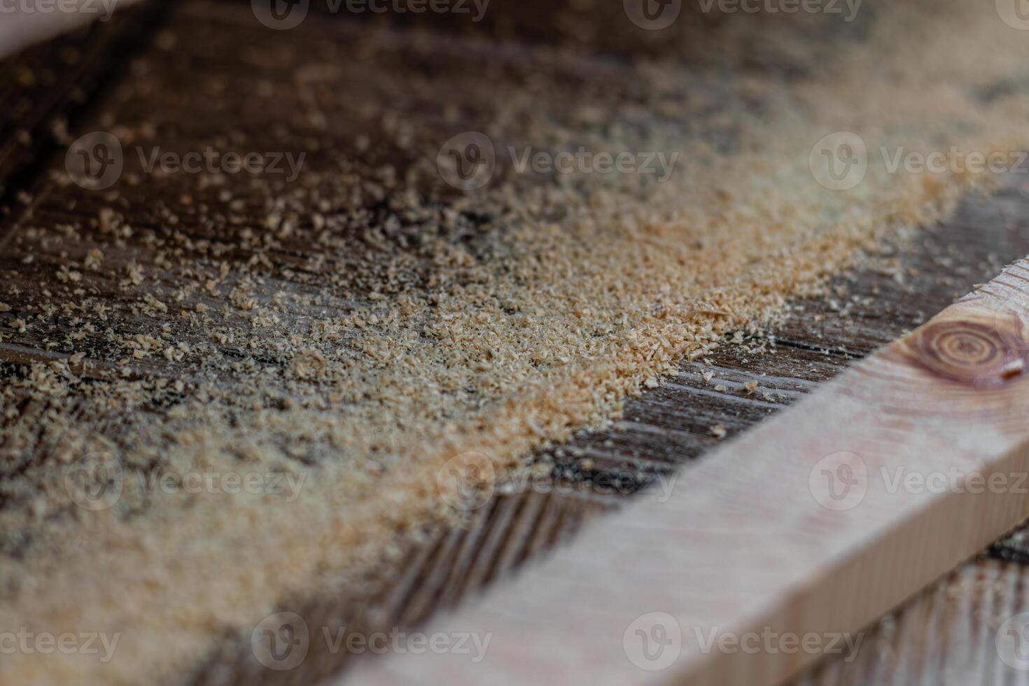 a cut off piece of board with an electric jigsaw on the floor photo