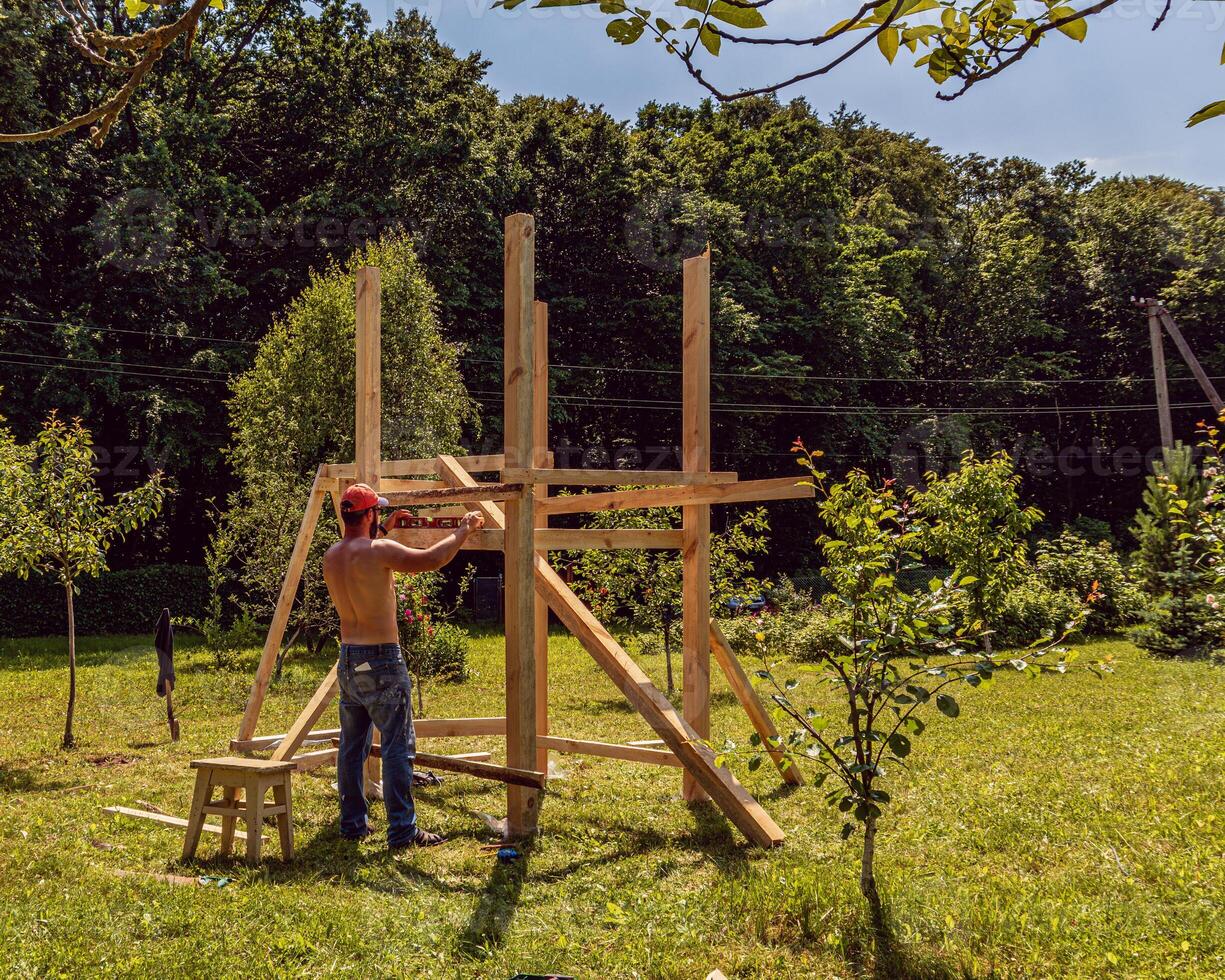 A small playground. Children's wooden house. Children's swing photo