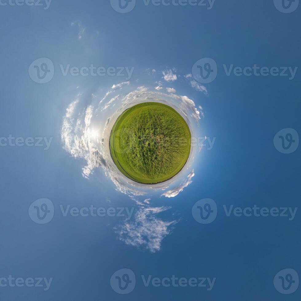 simple tiny planet without buildings in blue sky with beautiful clouds. Transformation of spherical panorama 360 degrees. Spherical abstract aerial view. Curvature of space. photo