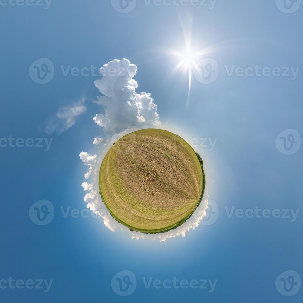 simple tiny planet without buildings in blue sky with beautiful clouds. Transformation of spherical panorama 360 degrees. Spherical abstract aerial view. Curvature of space. photo