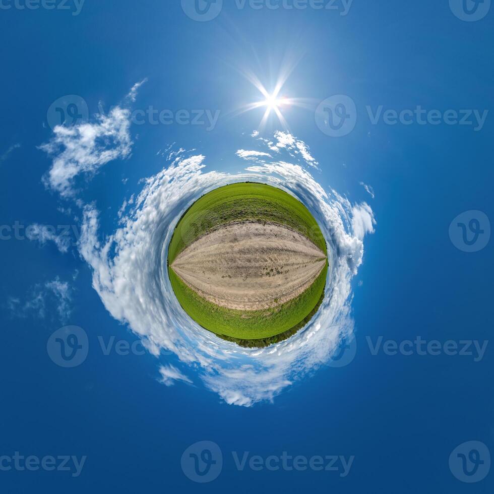 simple tiny planet without buildings in blue sky with beautiful clouds. Transformation of spherical panorama 360 degrees. Spherical abstract aerial view. Curvature of space. photo