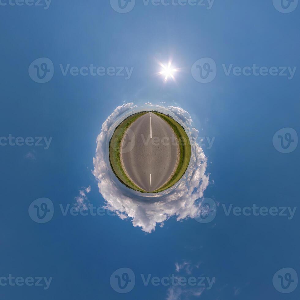 simple tiny planet without buildings in blue sky with beautiful clouds. Transformation of spherical panorama 360 degrees. Spherical abstract aerial view. Curvature of space. photo