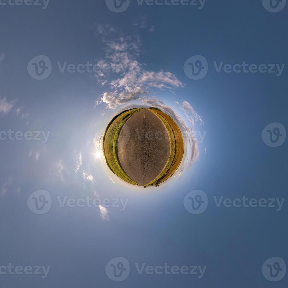 simple tiny planet without buildings in blue sky with beautiful clouds. Transformation of spherical panorama 360 degrees. Spherical abstract aerial view. Curvature of space. photo