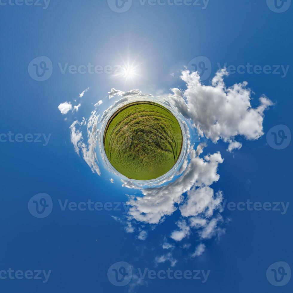 simple tiny planet without buildings in blue sky with beautiful clouds. Transformation of spherical panorama 360 degrees. Spherical abstract aerial view. Curvature of space. photo