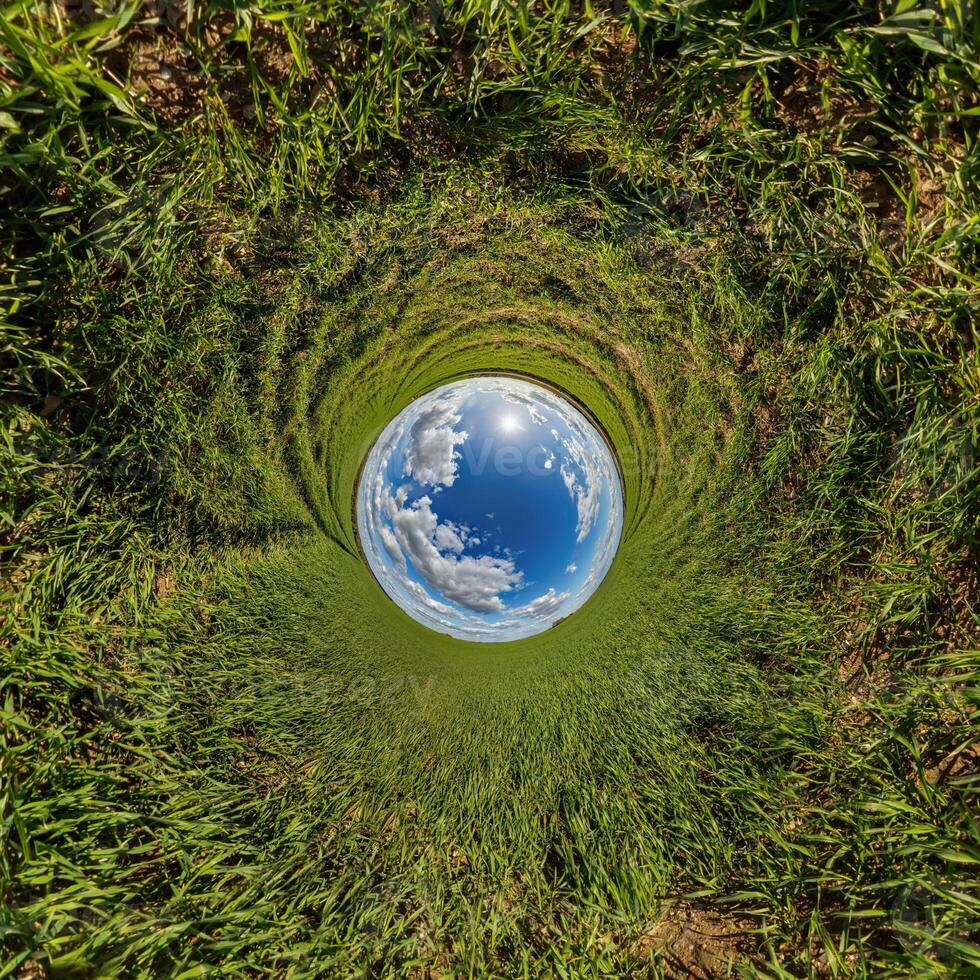 blue hole sphere or globe little planet inside sand or dry grass round frame background photo
