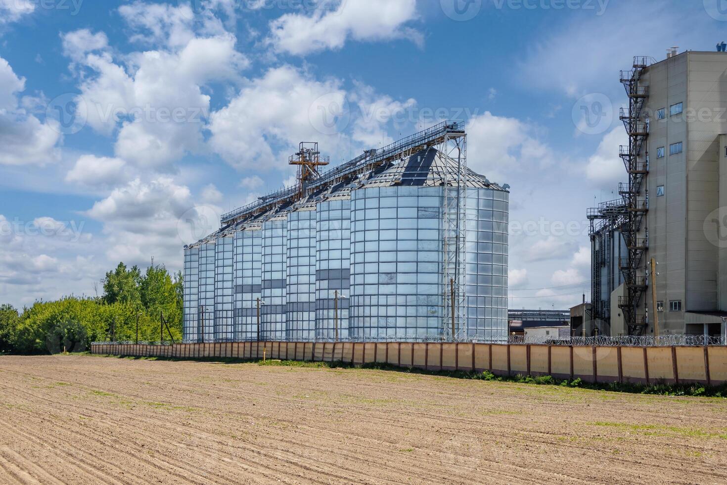 silos granary elevator on agro-industrial complex with seed cleaning and drying line for grain storage photo