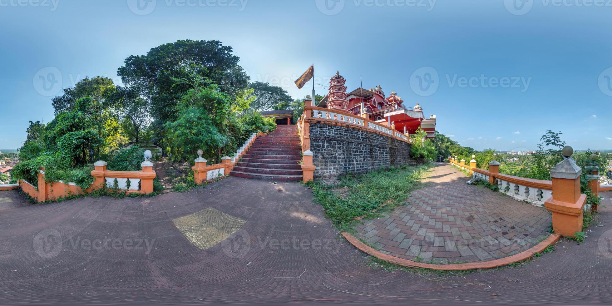 full hdri 360 panorama near red hindu maruti temple of ape goddess hanuman on high mountain in jungle among palm trees in Indian tropic town in equirectangular projection. VR AR content photo