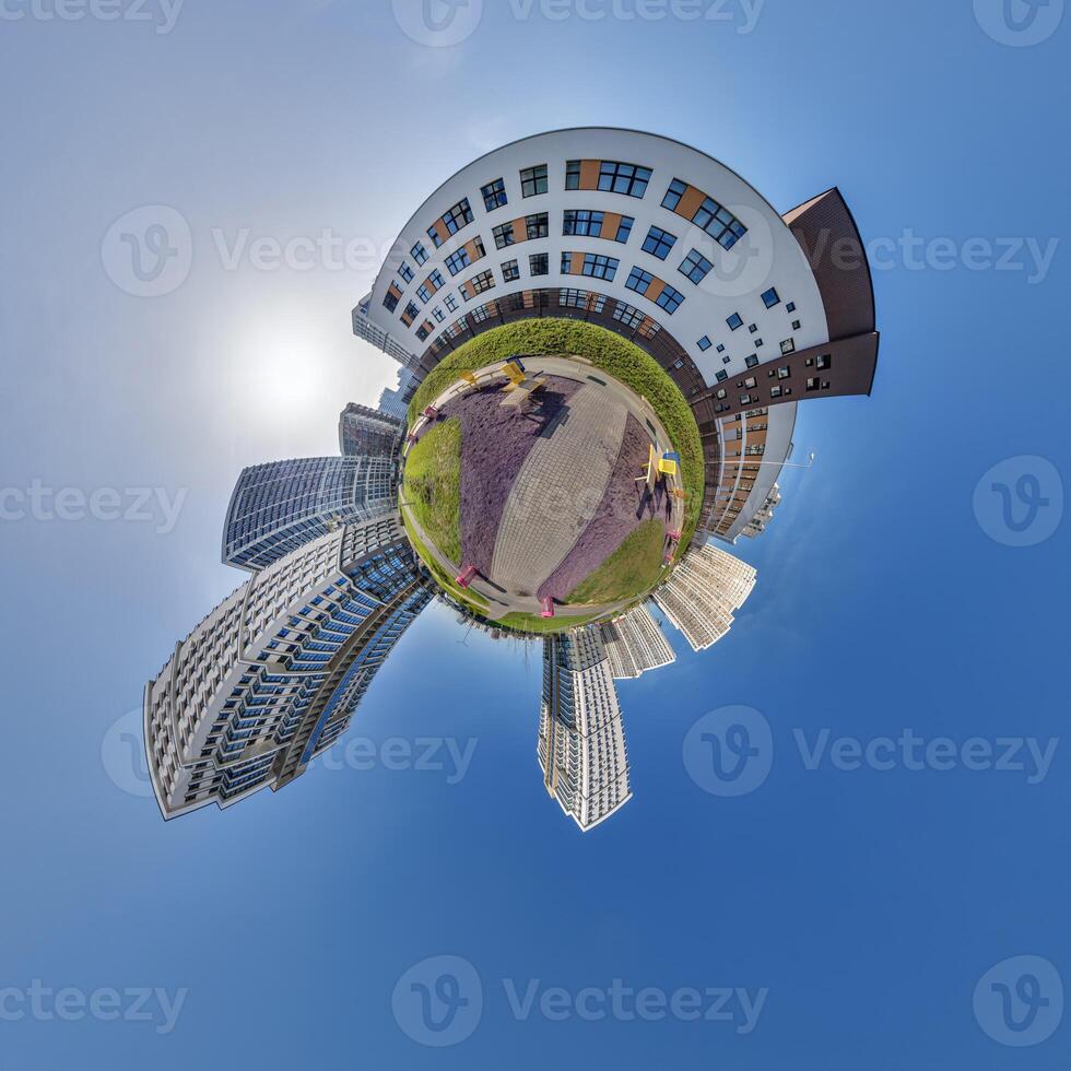 abstract swirling tiny planet spherical panorama of multi-storey buildings of skyscrapers of a residential complex in the form of a butterfly in blue sky photo