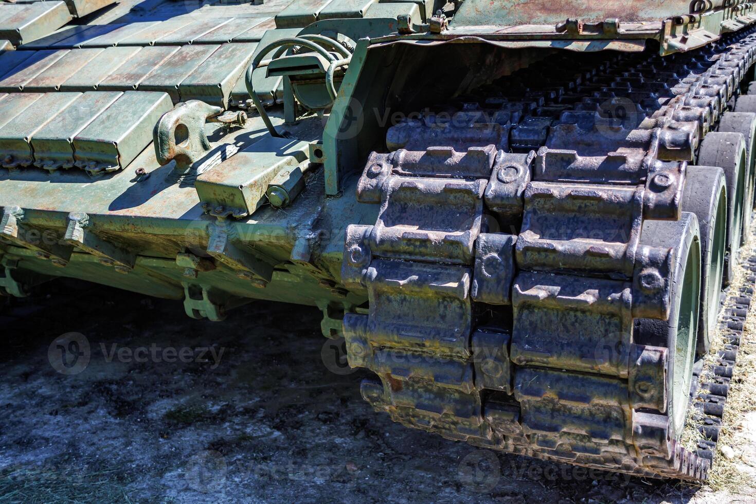 tracks and wheels of tank t80, armored vehicles on the street in green khaki color photo